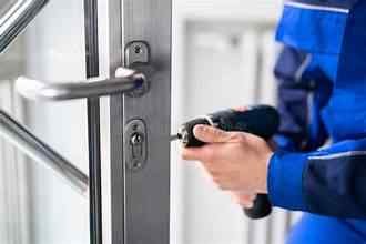 Emergency locksmith inspecting a door lock before drilling in Yelm Washington