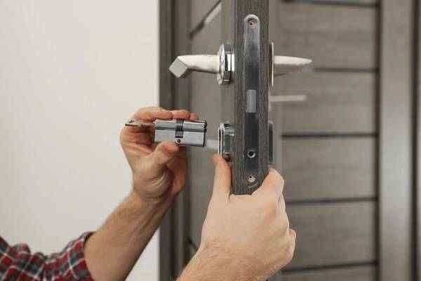 Commercial locksmith inspecting a business door in Yelm Washington